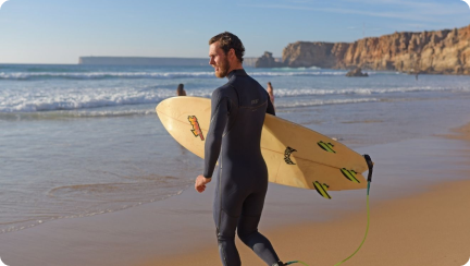 Surfer Walking on a Sagres beach